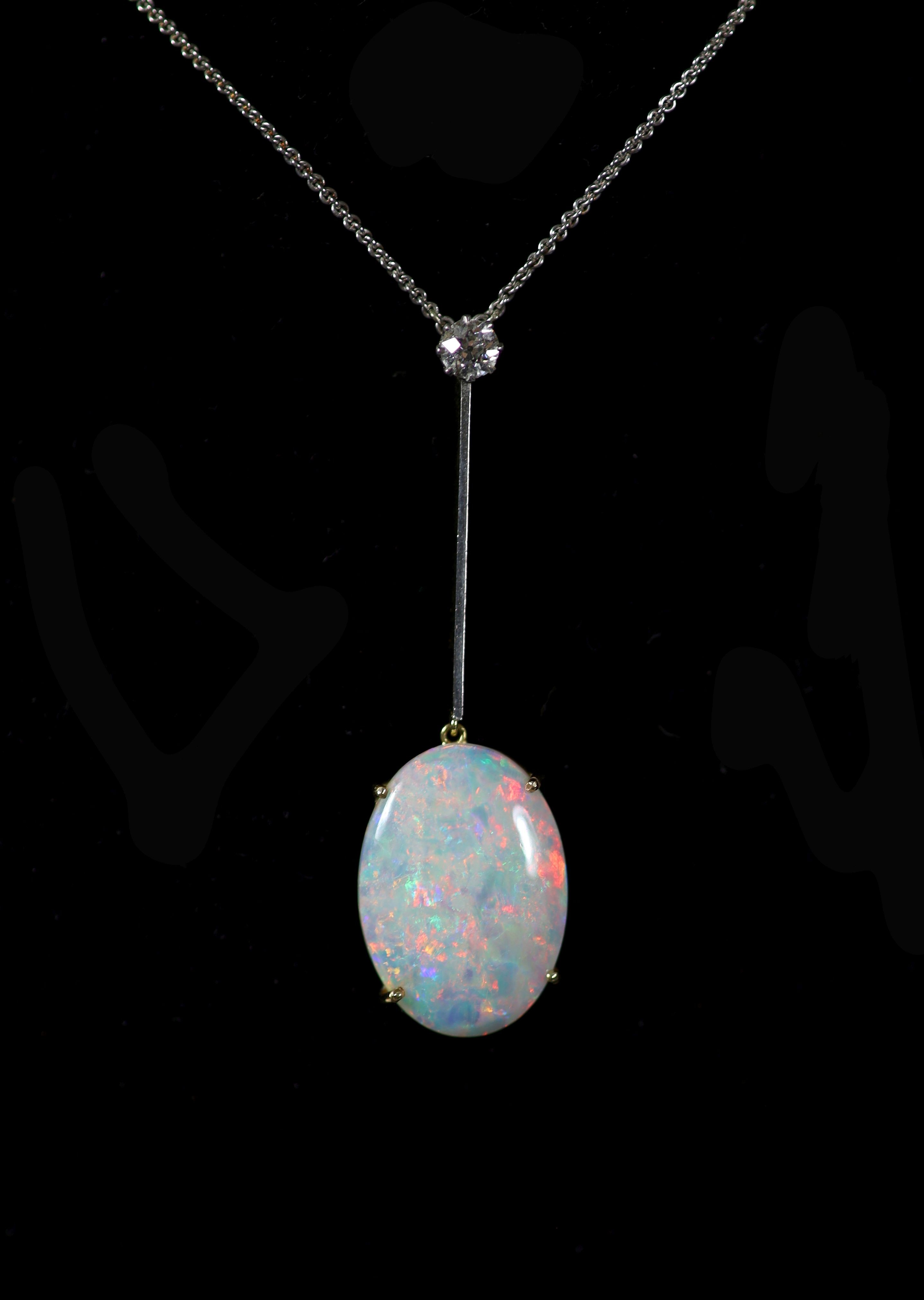 A 1920's gold, oval white opal and single stone diamond set drop pendant, on a platinum fine link chain